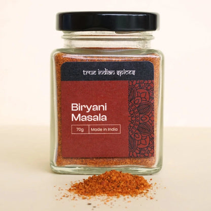 Close-up of a jar filled with biryani masala spice mix, featuring a colourful blend of aromatic Indian spices.