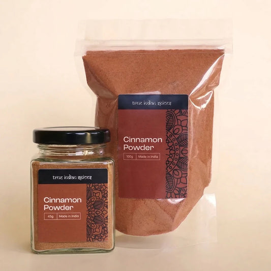 Jar and bag of cinnamon powder with 'True Indian Spice' branding on a beige background