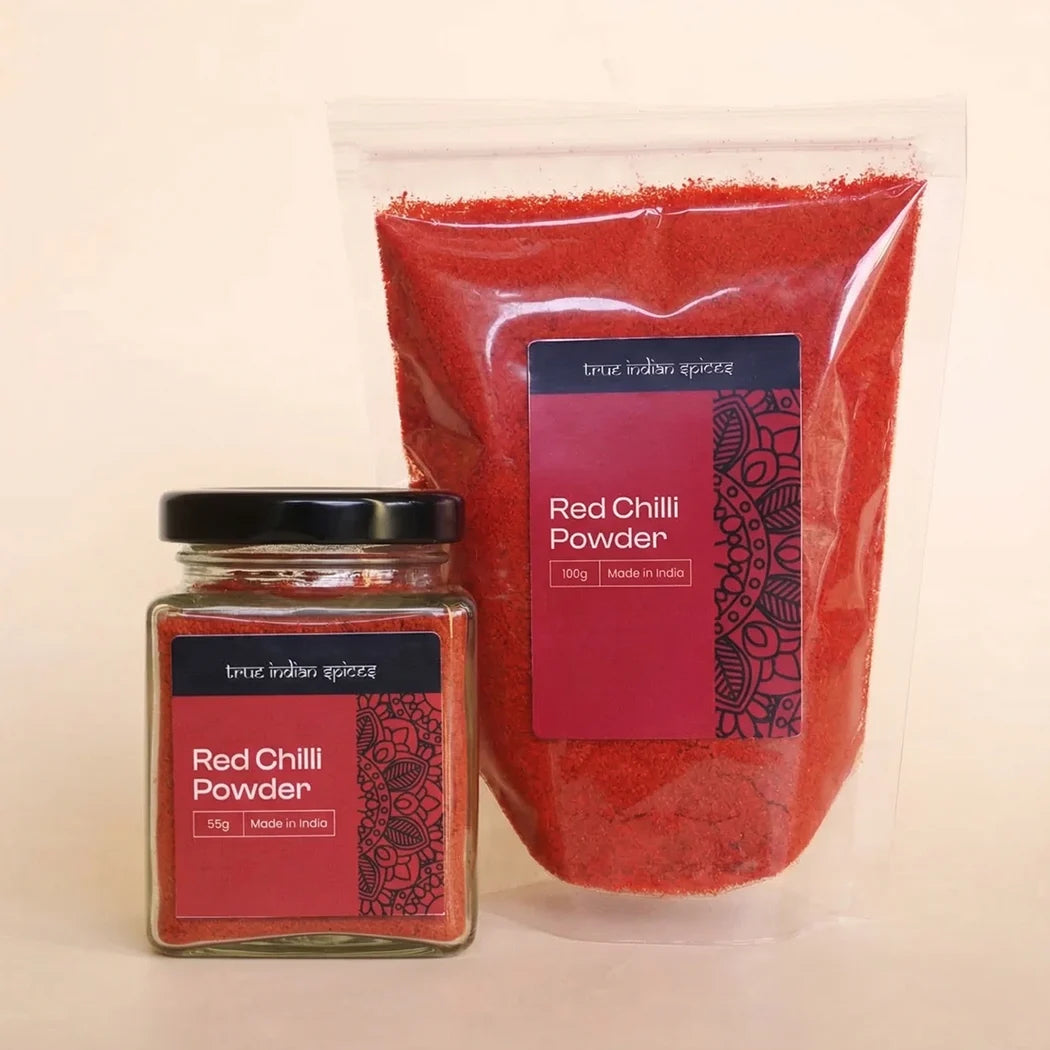 Jar and bag of red chilli powder with 'true indian spices' branding on a beige background