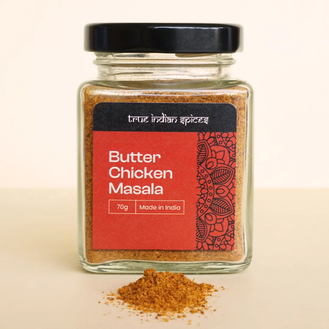 Close-up of a jar filled with butter chicken spice mix, featuring a colourful blend of Indian spices.